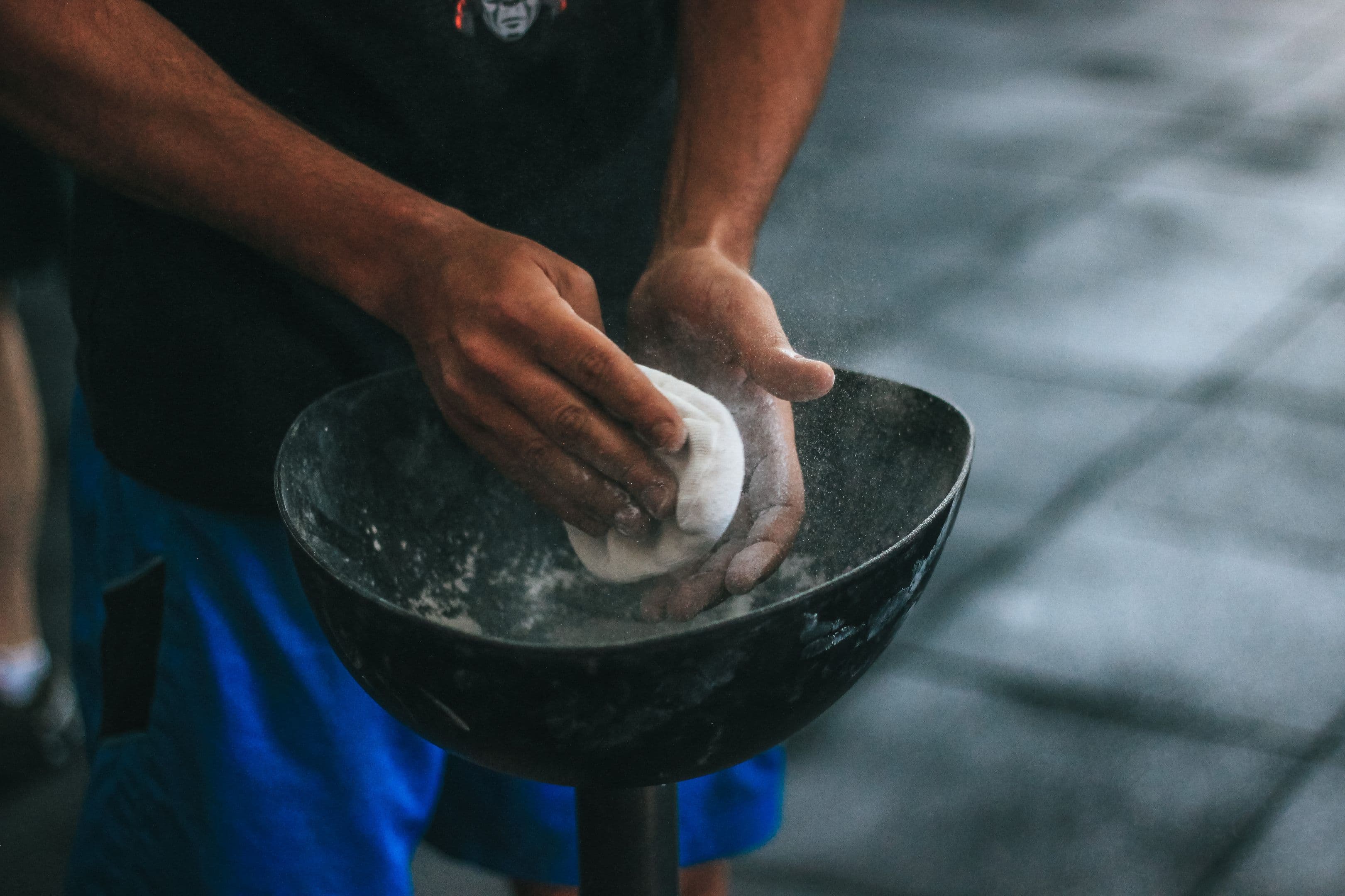 Chalked hands on a barbell